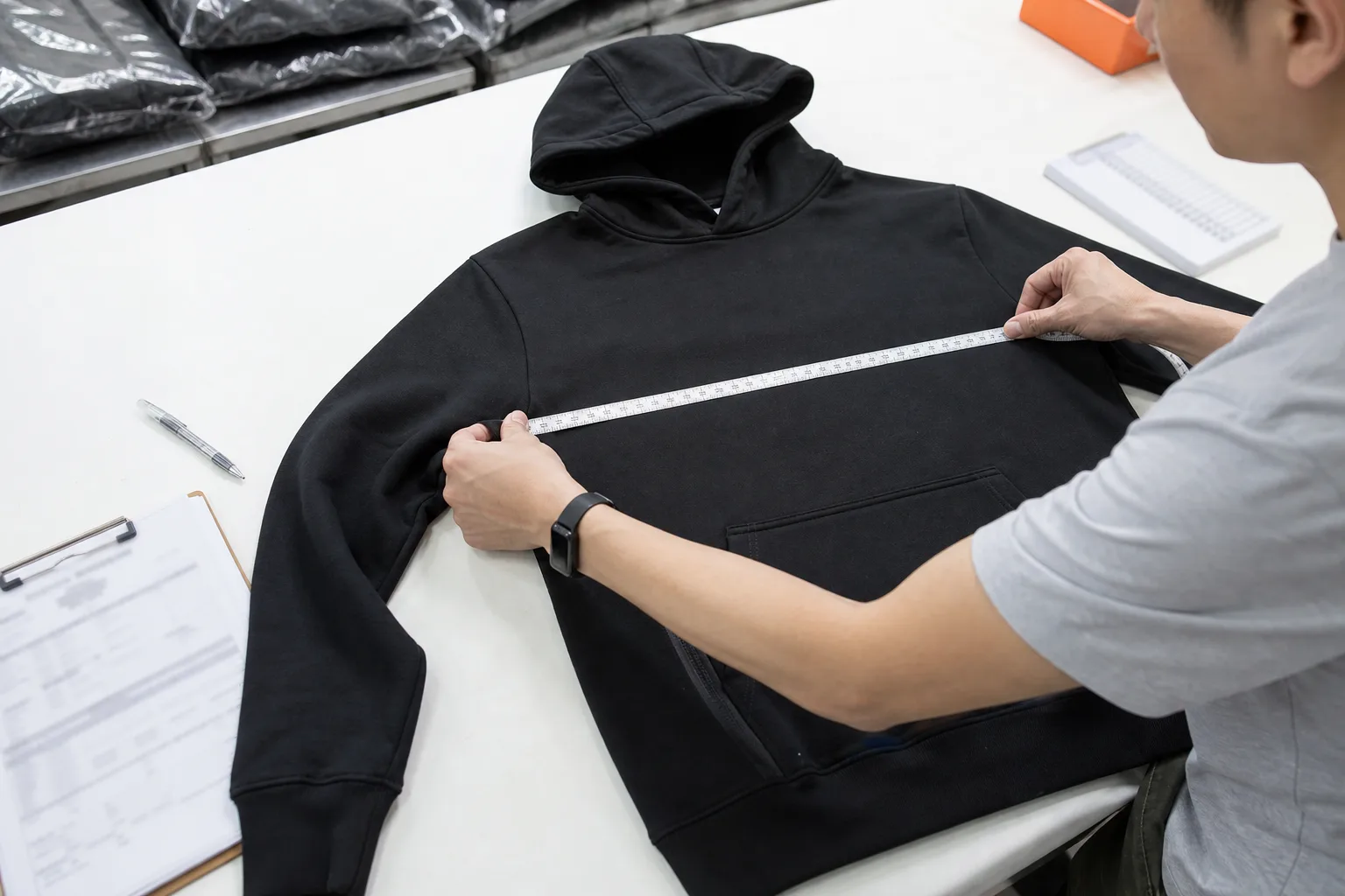 Quality-control technician measuring an apparel sample before bulk approval